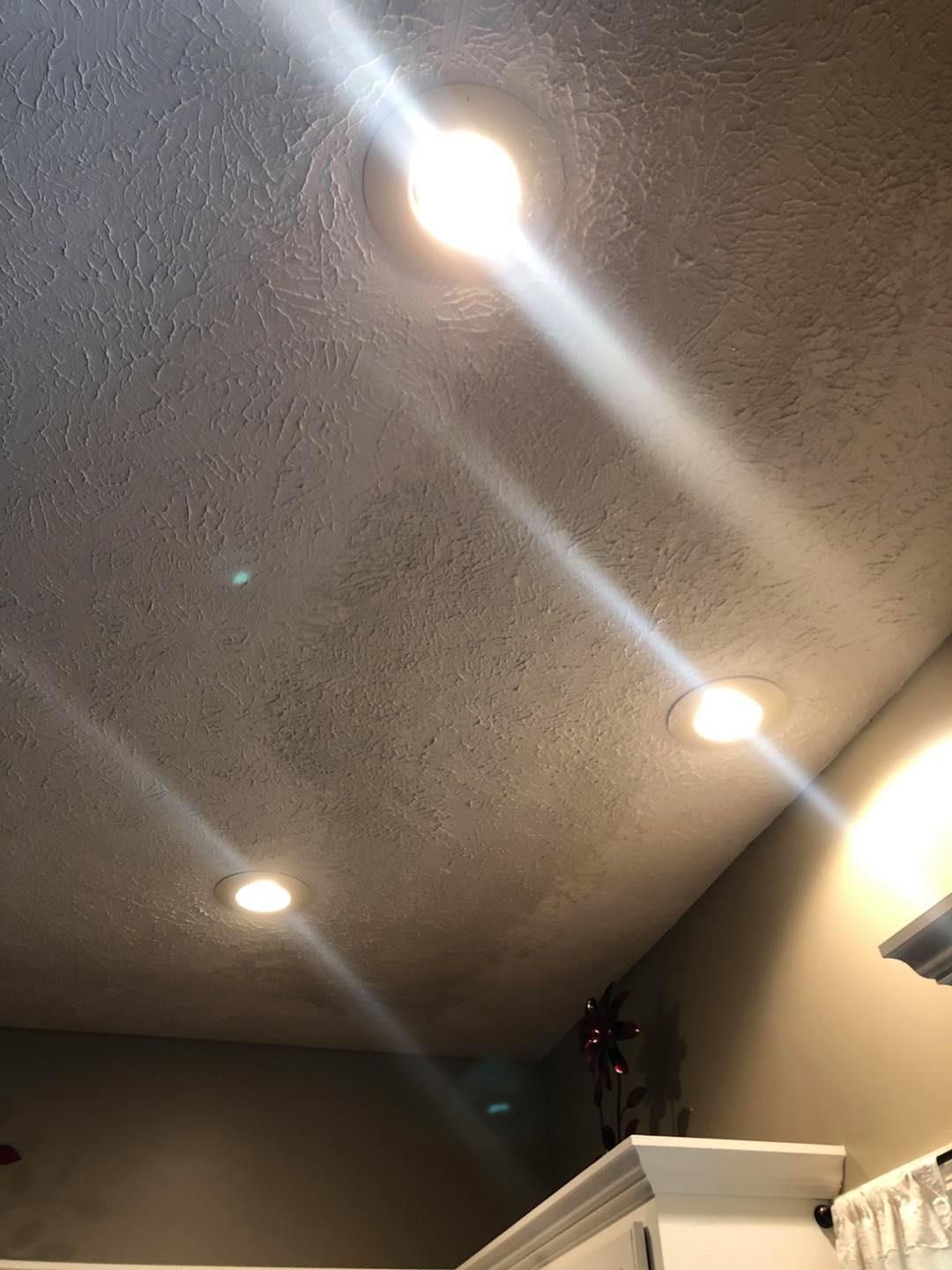A ceiling with a lot of lights on it in a room.