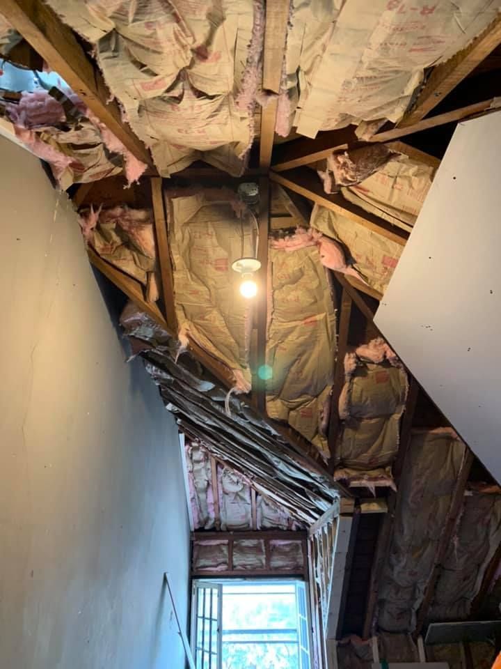 A room with a lot of insulation on the ceiling and a light on the ceiling.