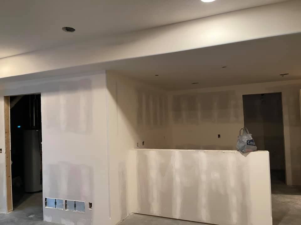 A room with drywall walls and a counter in it.