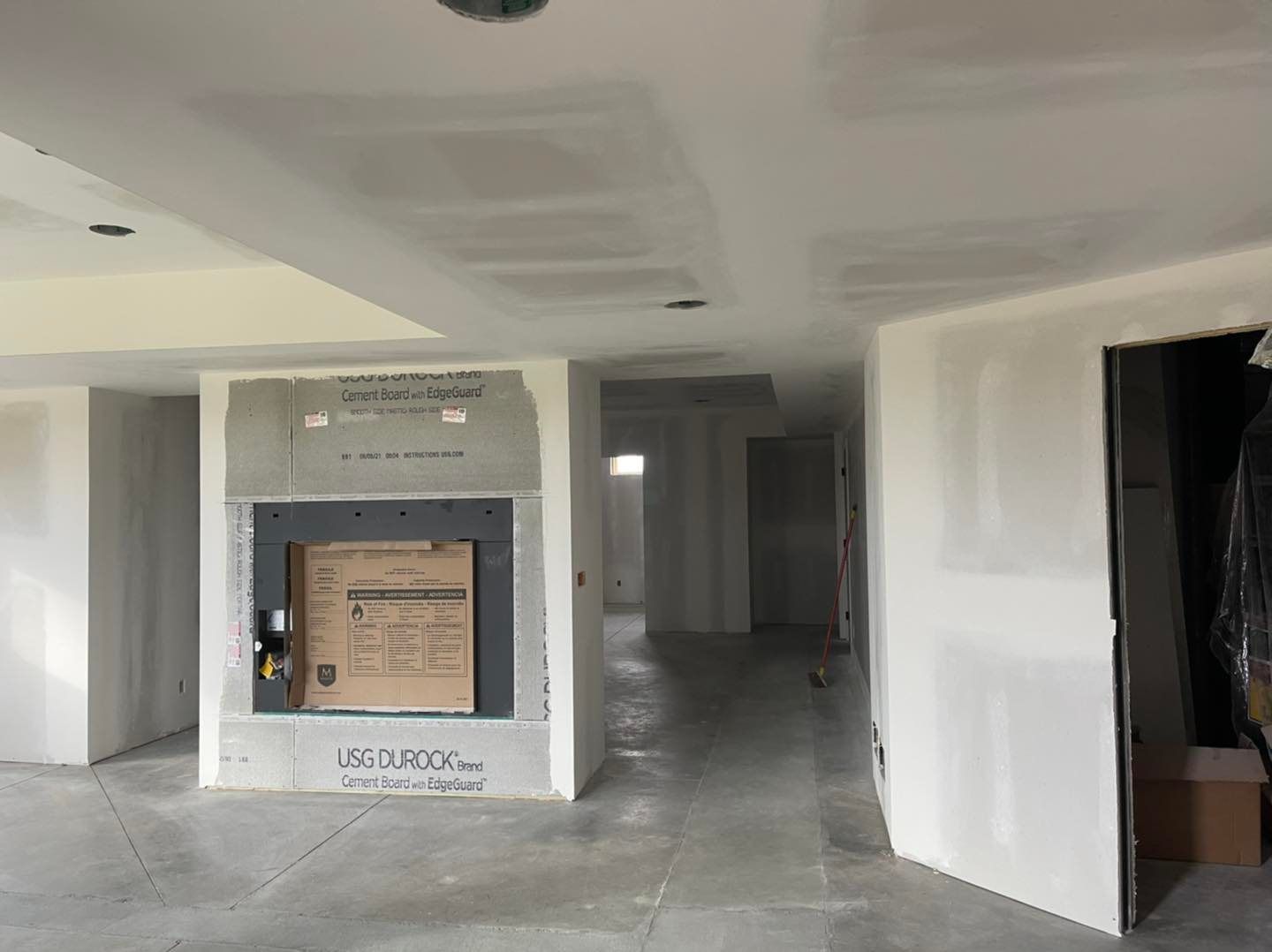 An empty room with a fireplace in the middle of it