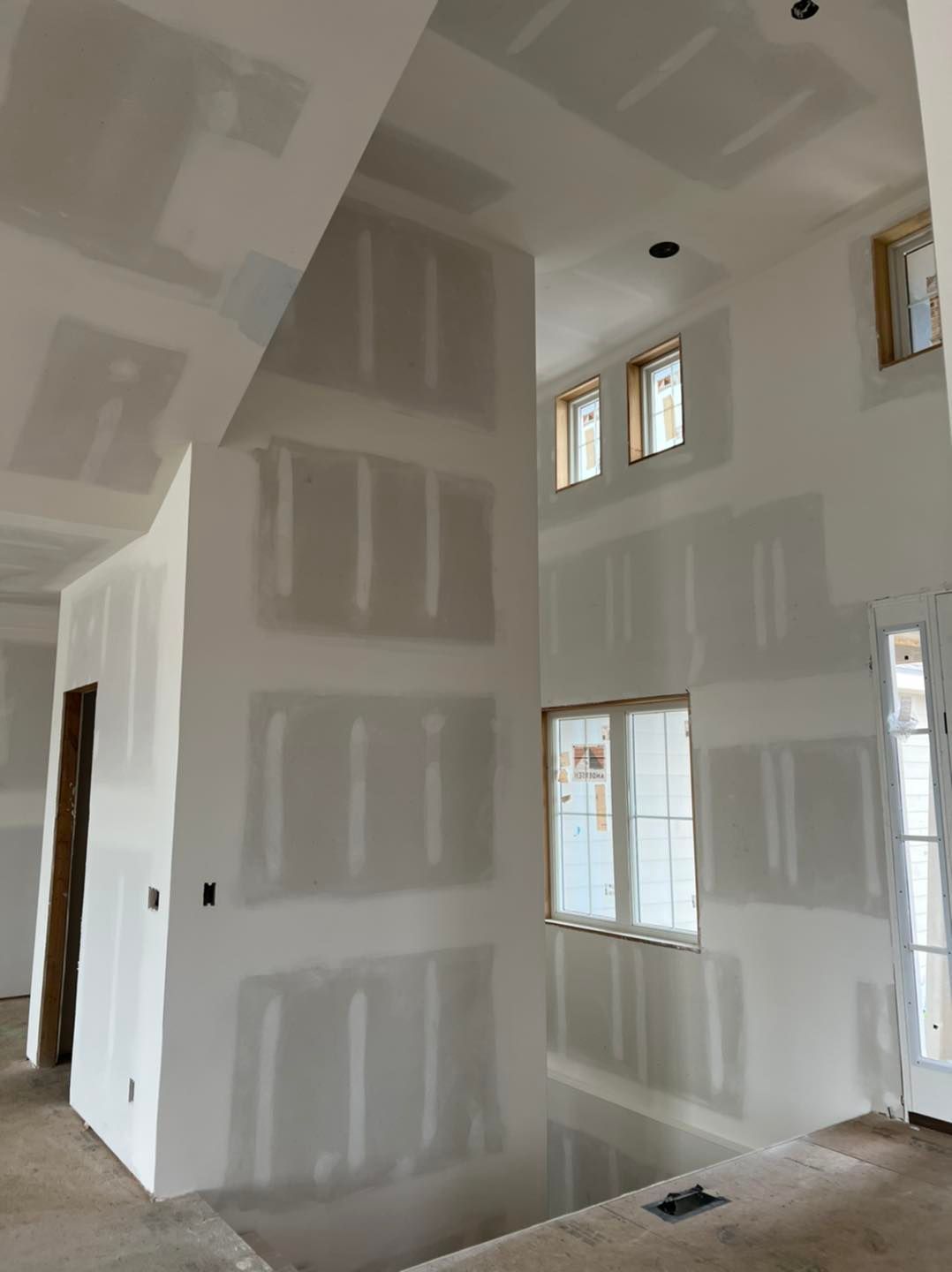 A room with a lot of white walls and windows.