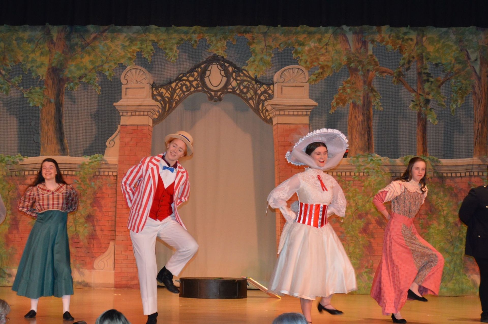 a group of people are dancing on a stage