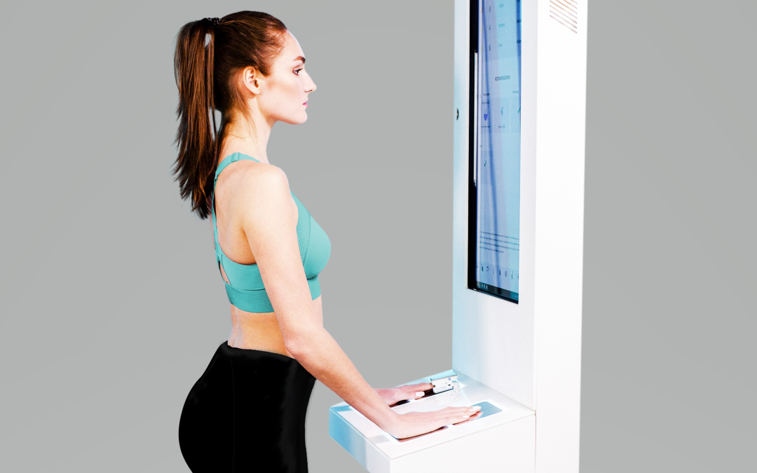 A woman is standing in front of a computer screen.