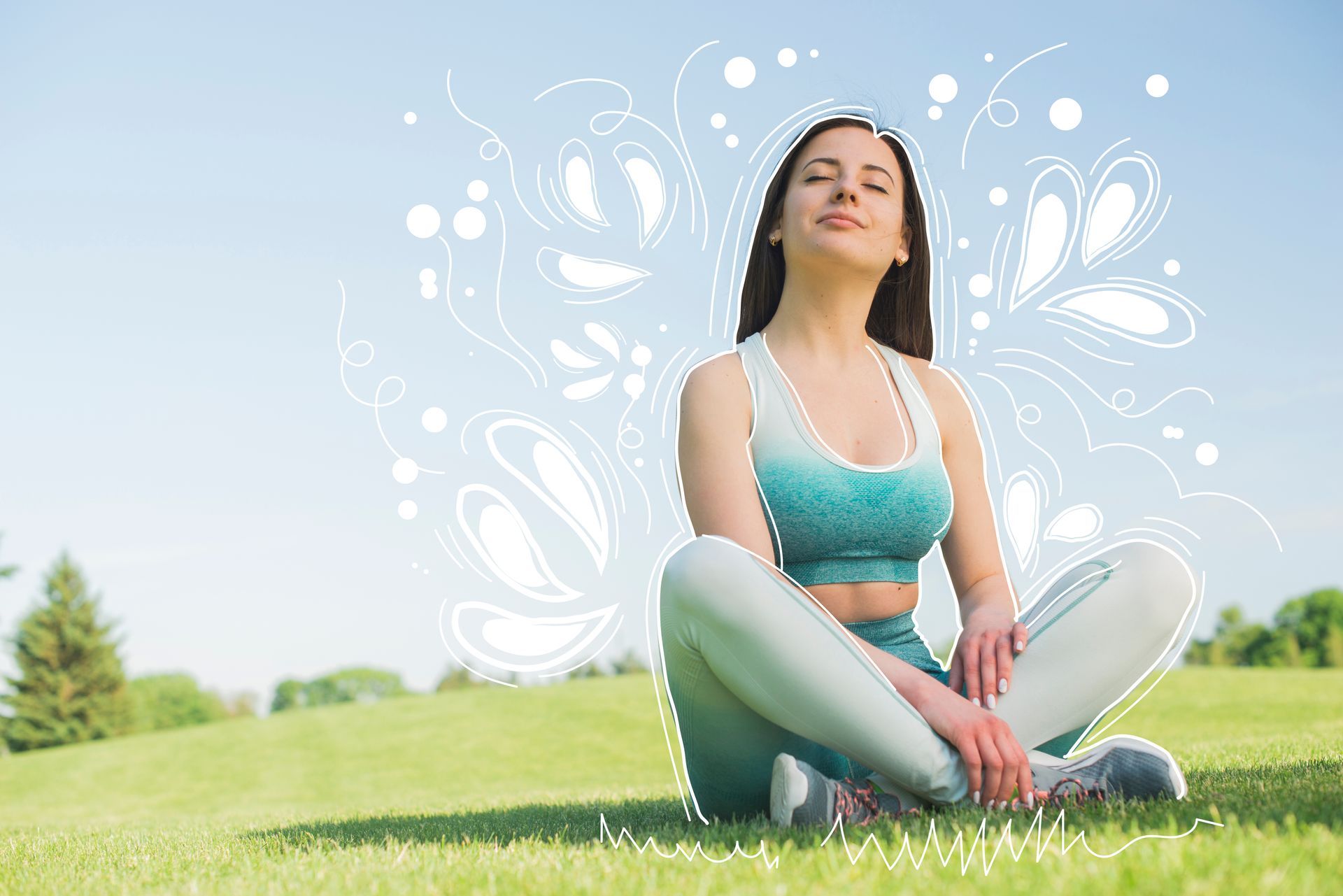 A woman is sitting in a lotus position on the grass with her eyes closed.