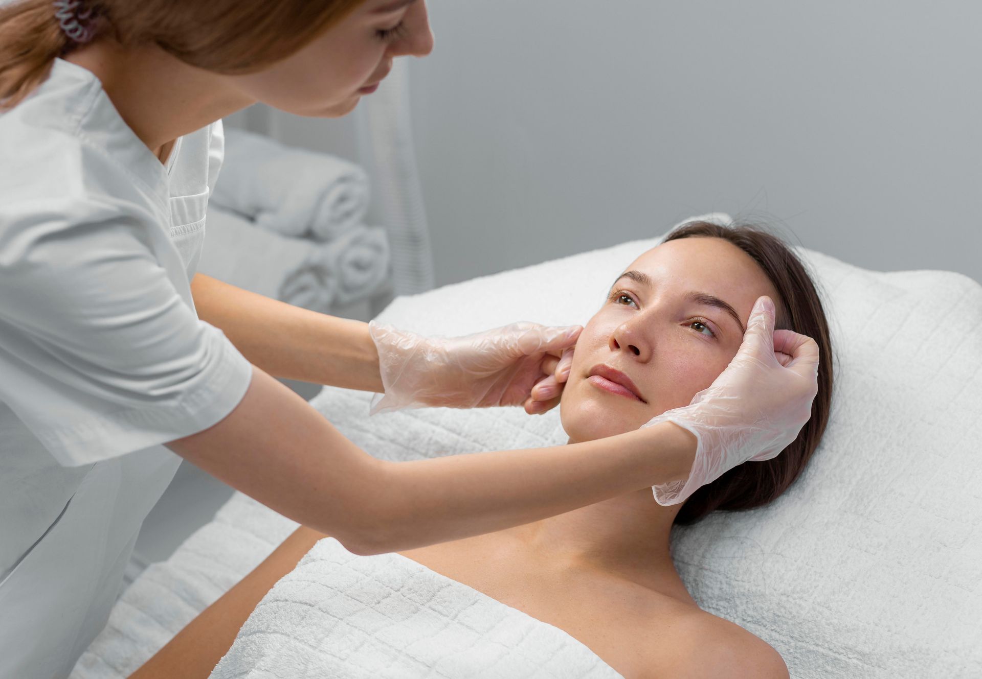 A woman is getting a facial treatment at a beauty salon.