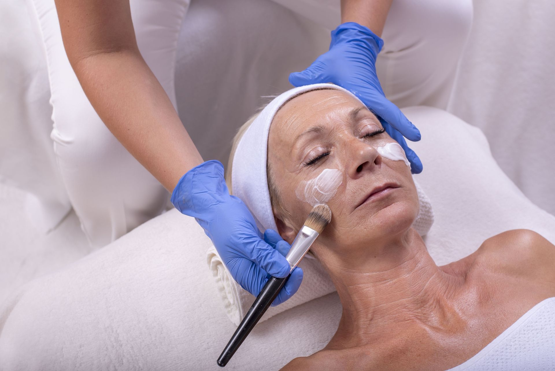 A woman is getting a facial treatment at a spa.