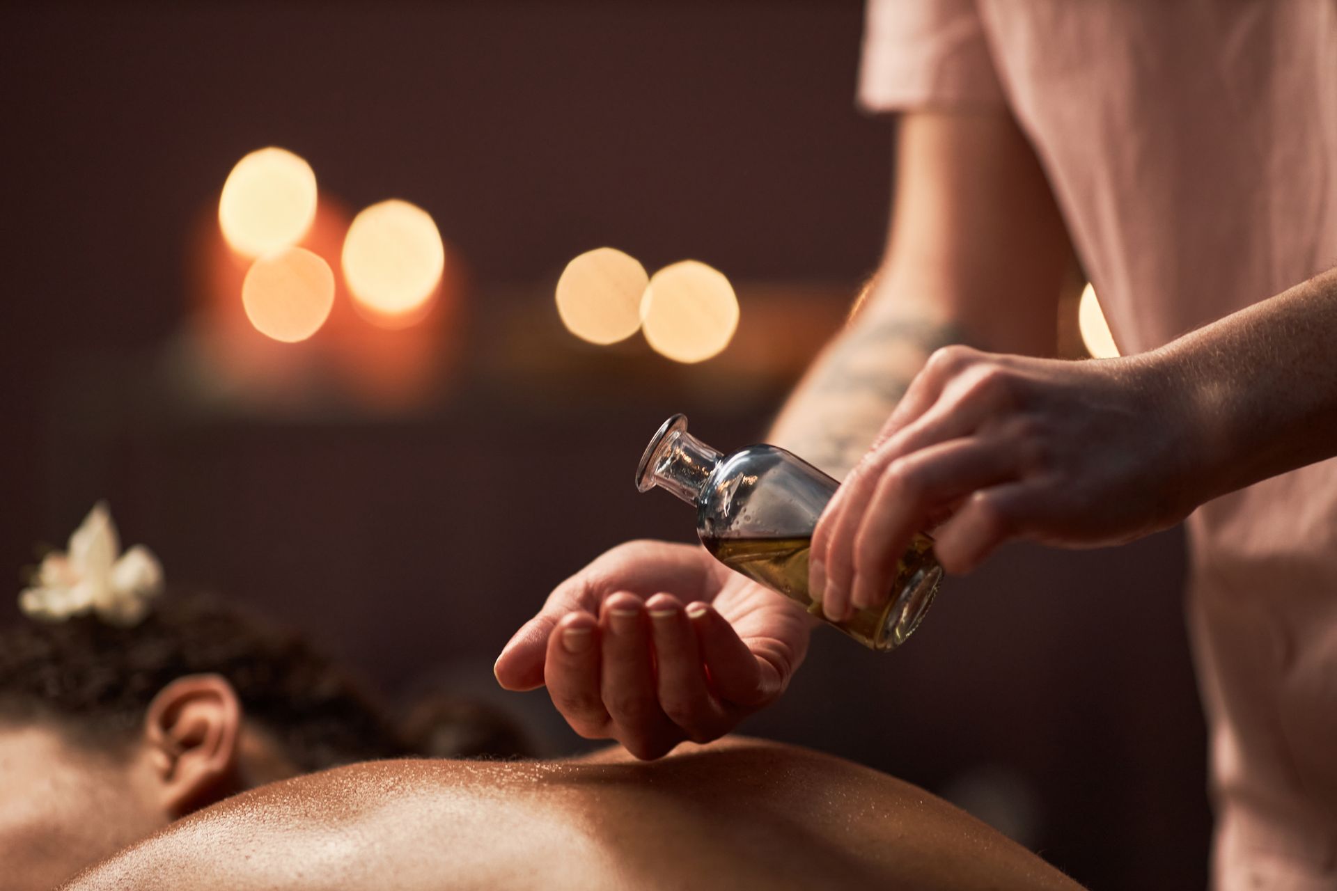 A woman is getting an oil massage at a spa.