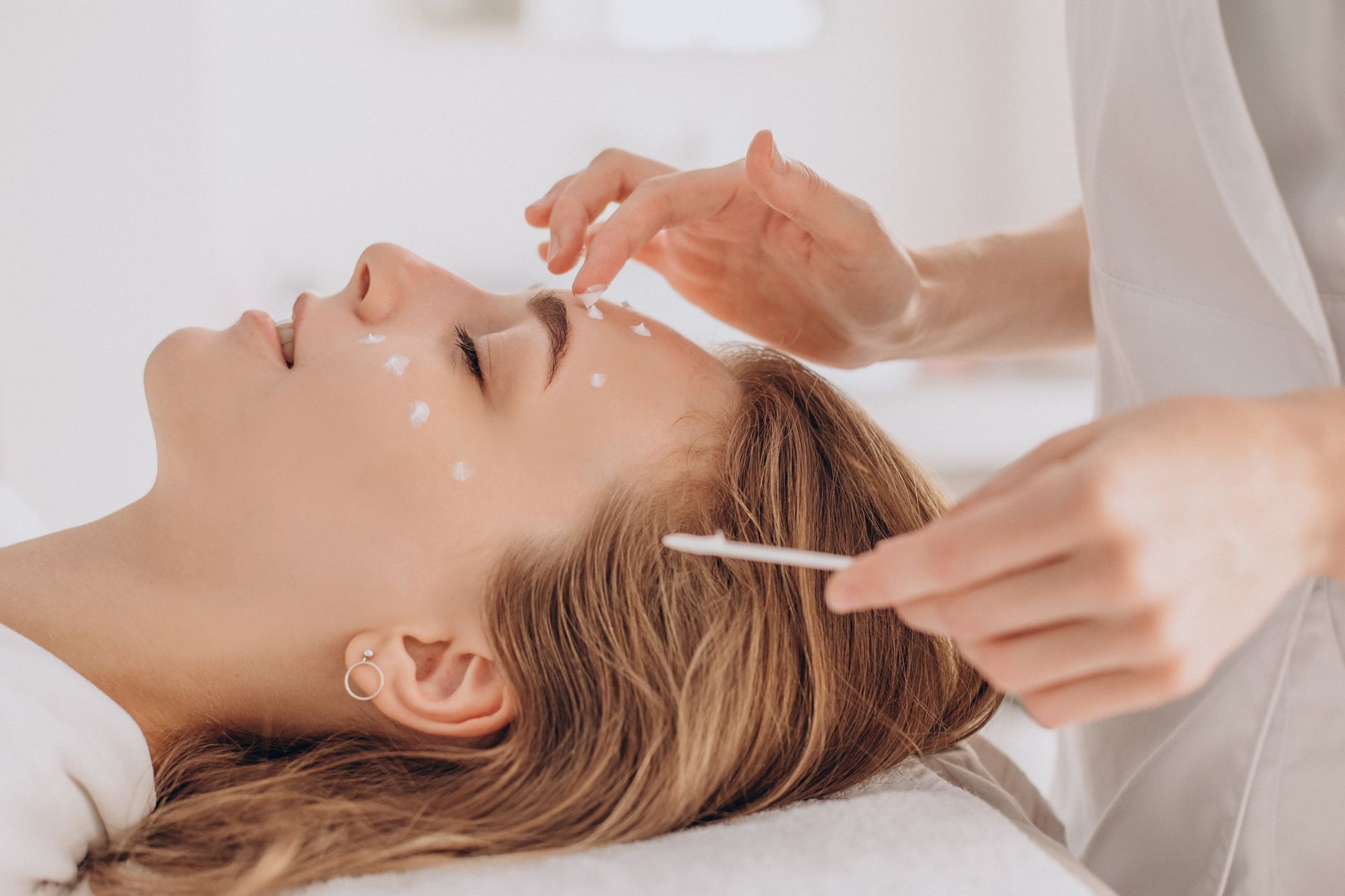 A woman is getting a facial treatment at a spa.