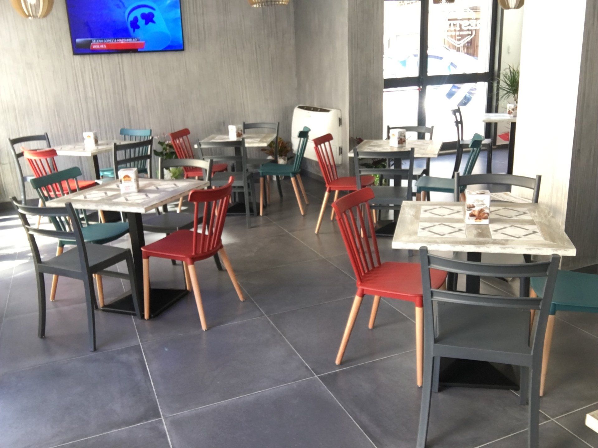 locale con sedie rosse e tavoli bianchi