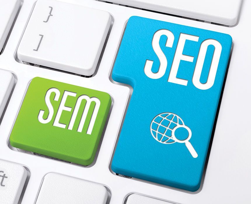 A computer keyboard with a blue and green button that says seo