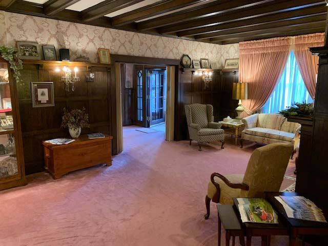 A living room with a couch and chairs in it