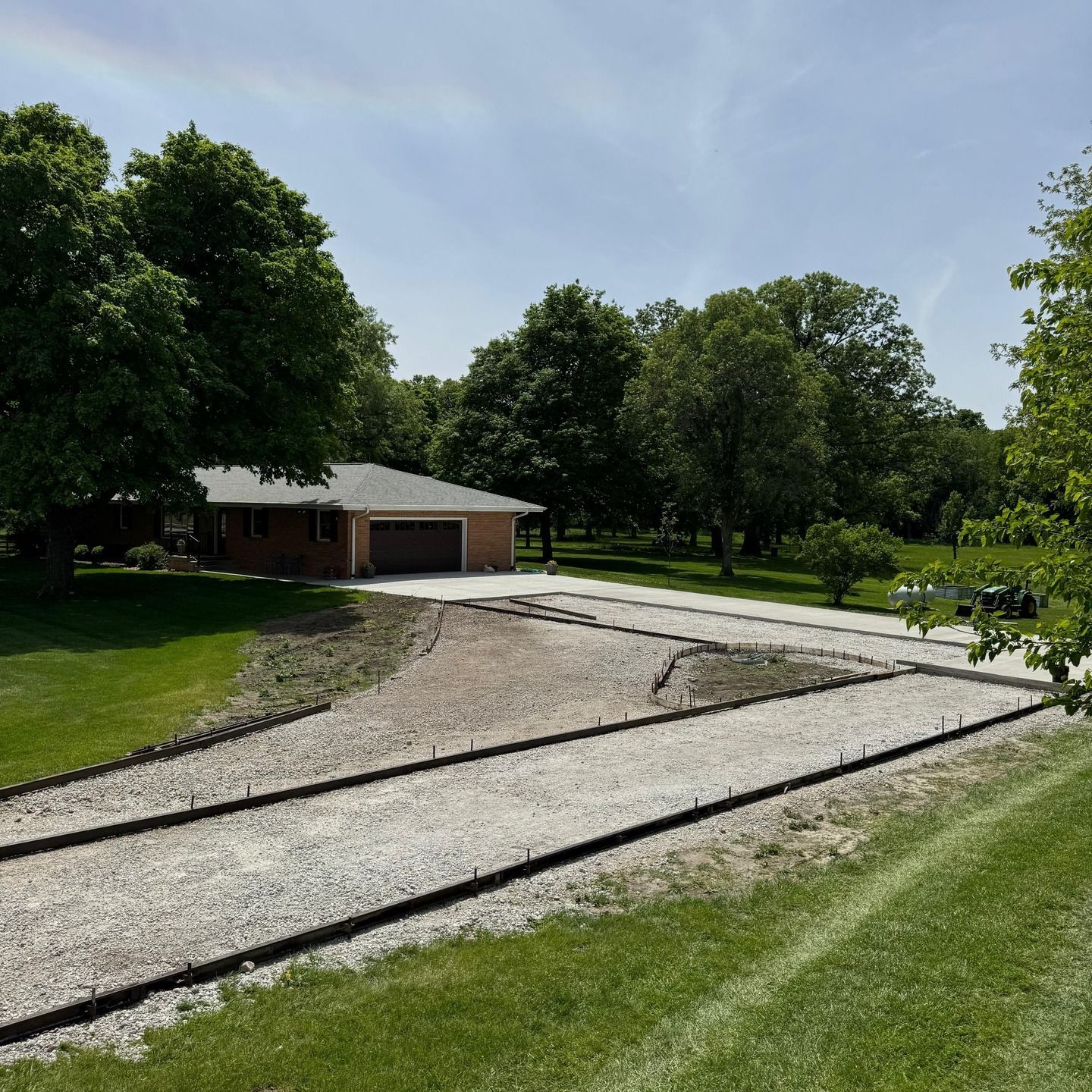 An aerial view of a driveway leading to a house