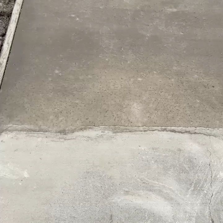A close up of a concrete sidewalk with a white border.