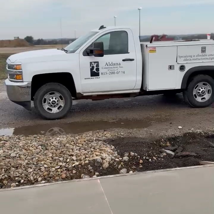 A white truck is parked on the side of the road