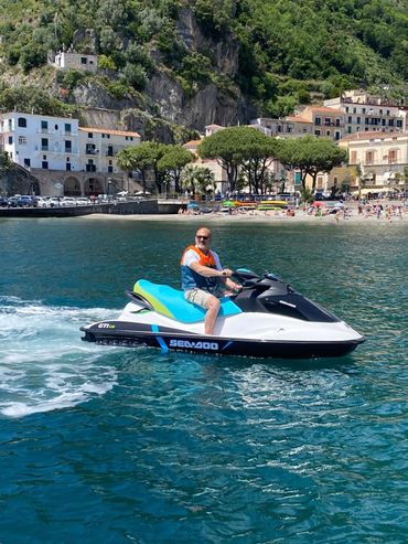 A man is riding a jet ski in the ocean.