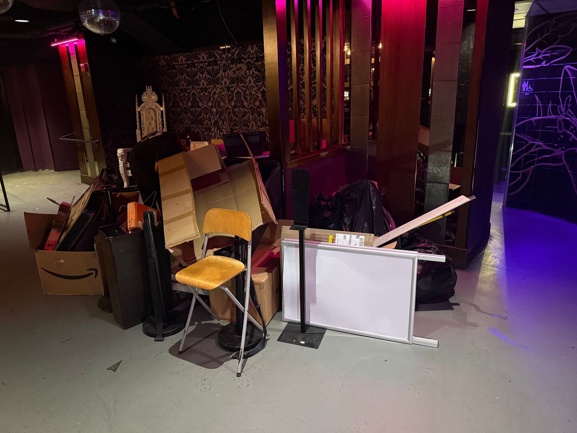 Building in mid-demolition, concrete structure and exposed framework against a blue sky.