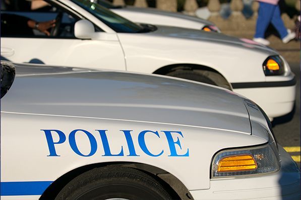 Two police cars are parked next to each other