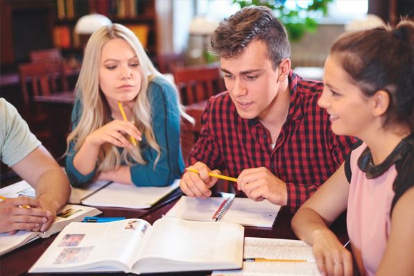 A group of students are studying together in a library.