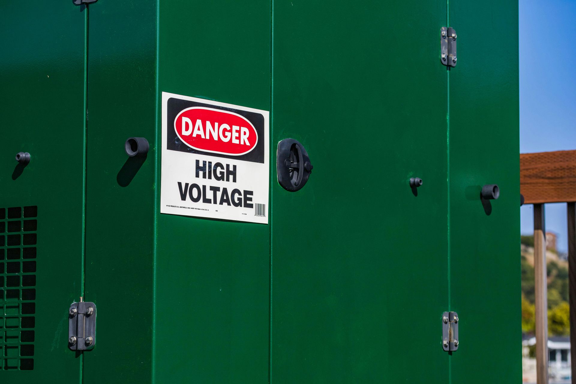Electrical transformer with high voltage danger sign showing need for surge protection