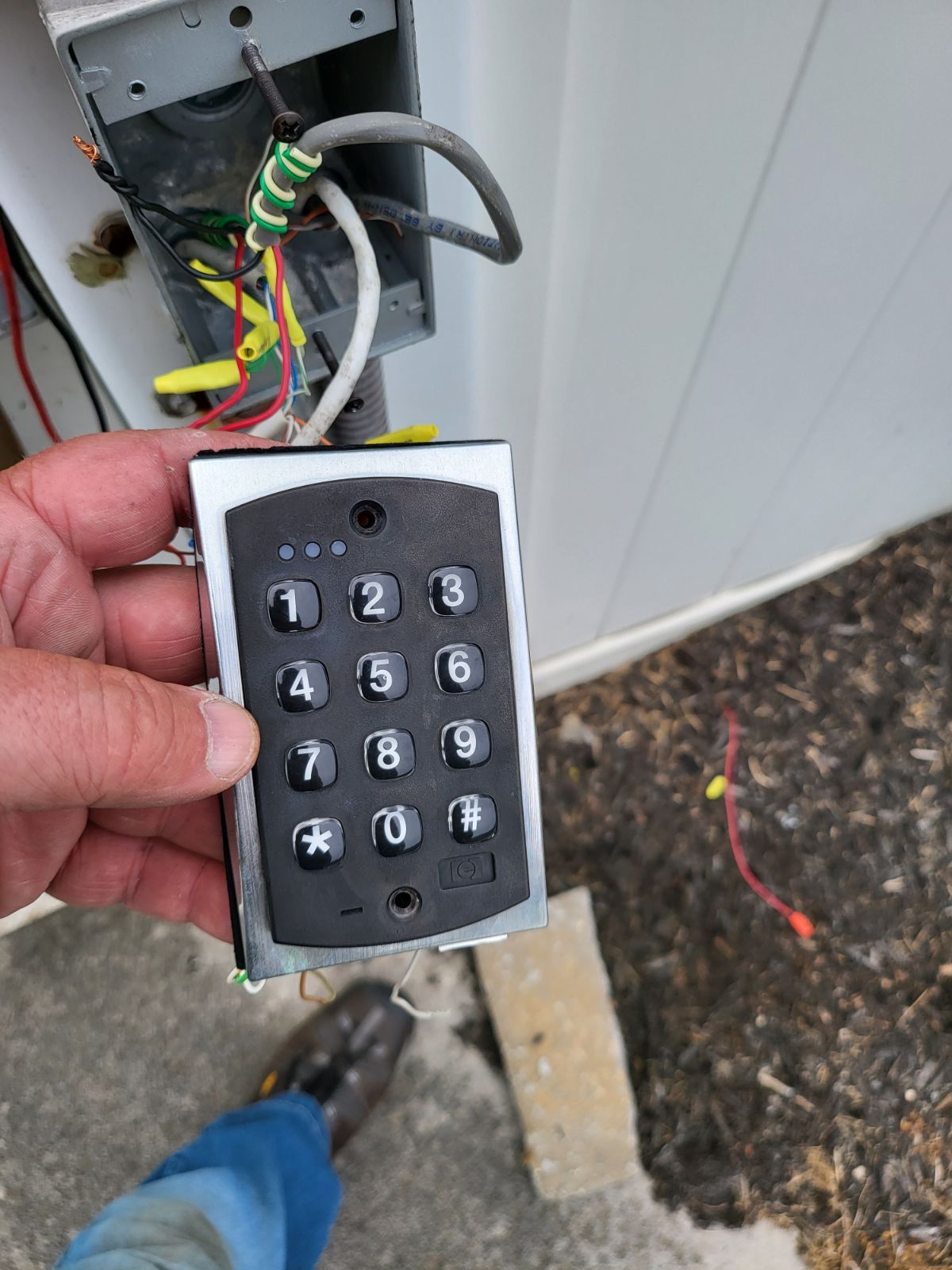 A person is holding a keypad in their hand.