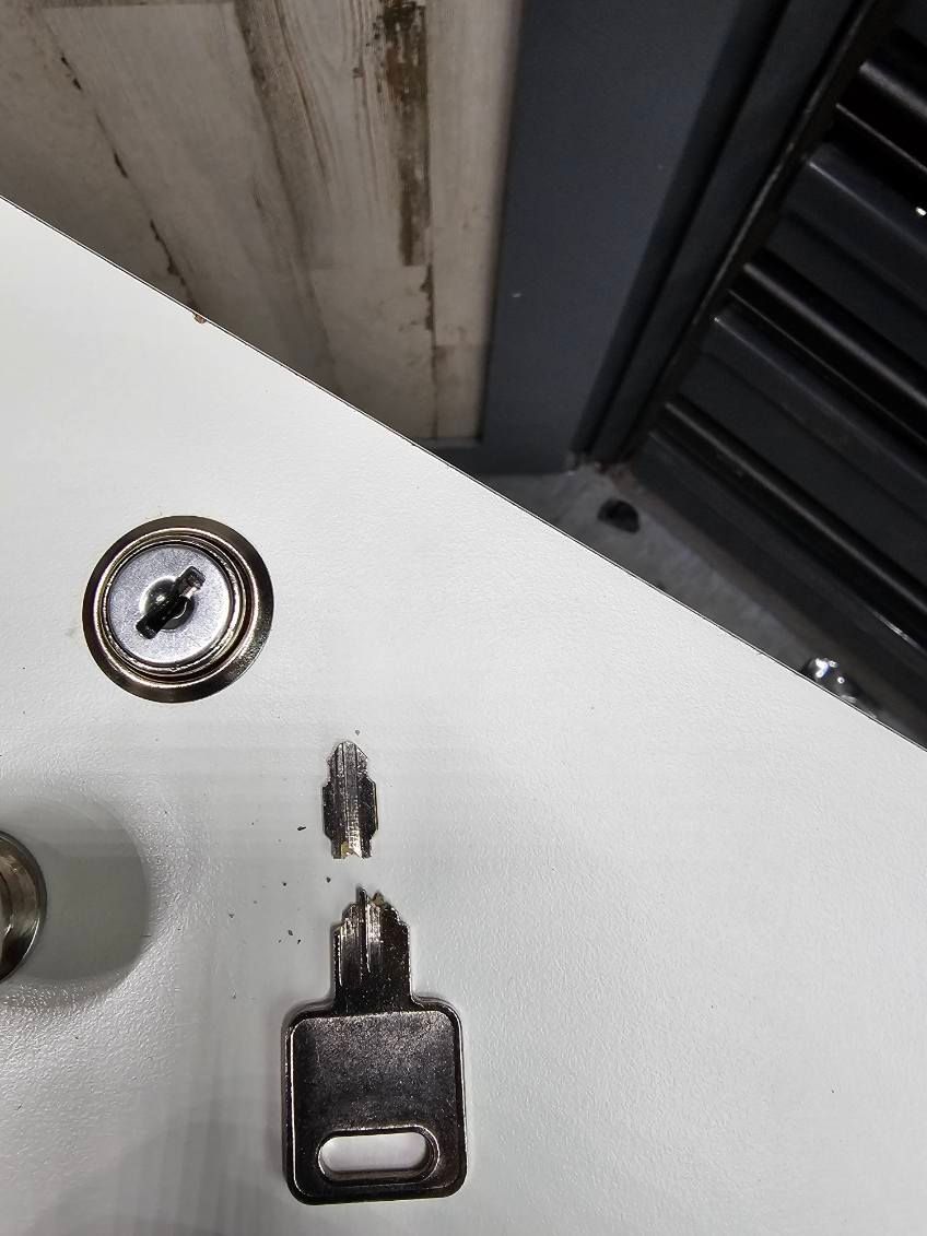 A close up of a key on a white surface