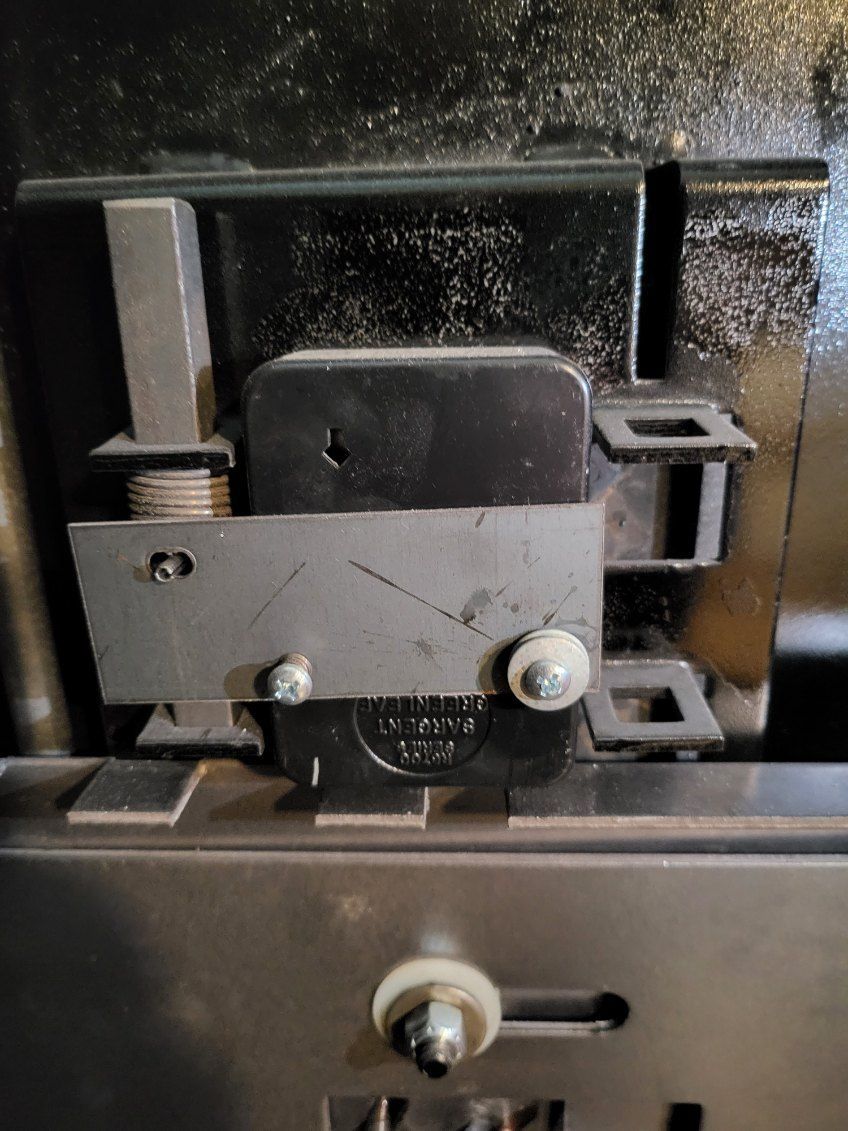 A close up of a metal object on a black surface.