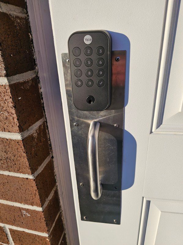 A close up of a door with a keypad on it.