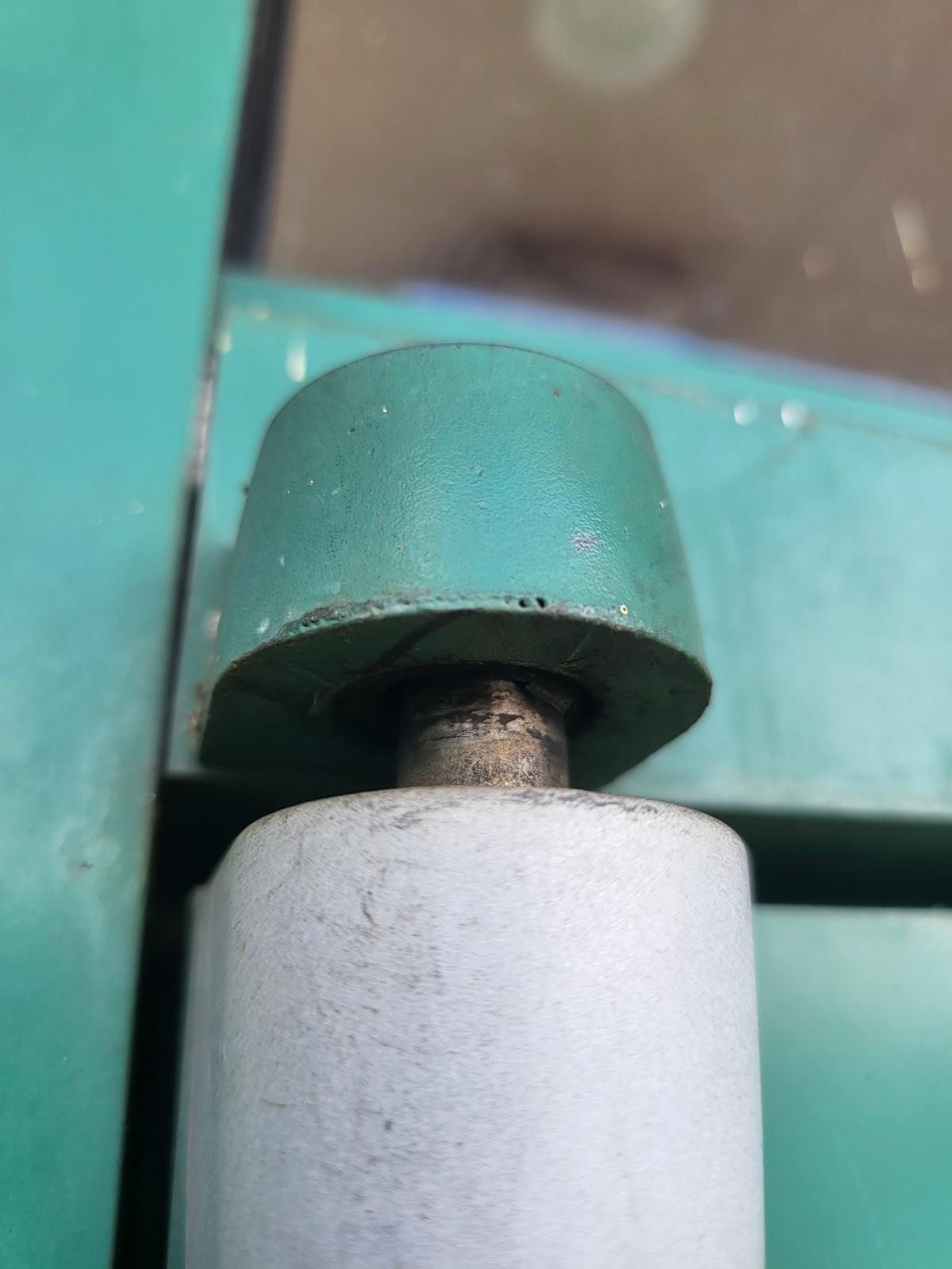 A close up of a green and white object on a green surface.