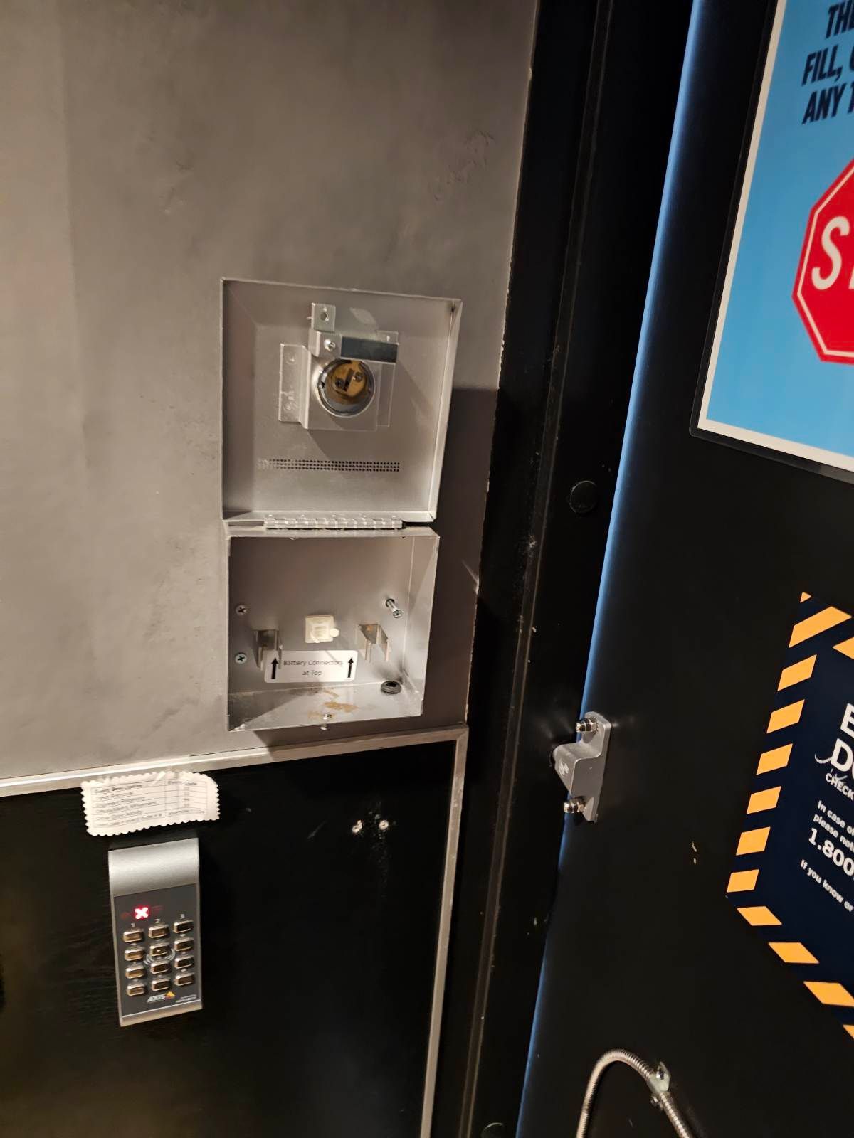 A black door with a stop sign on it