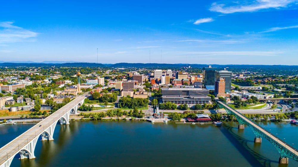 An aerial view of a city with a bridge over a river.