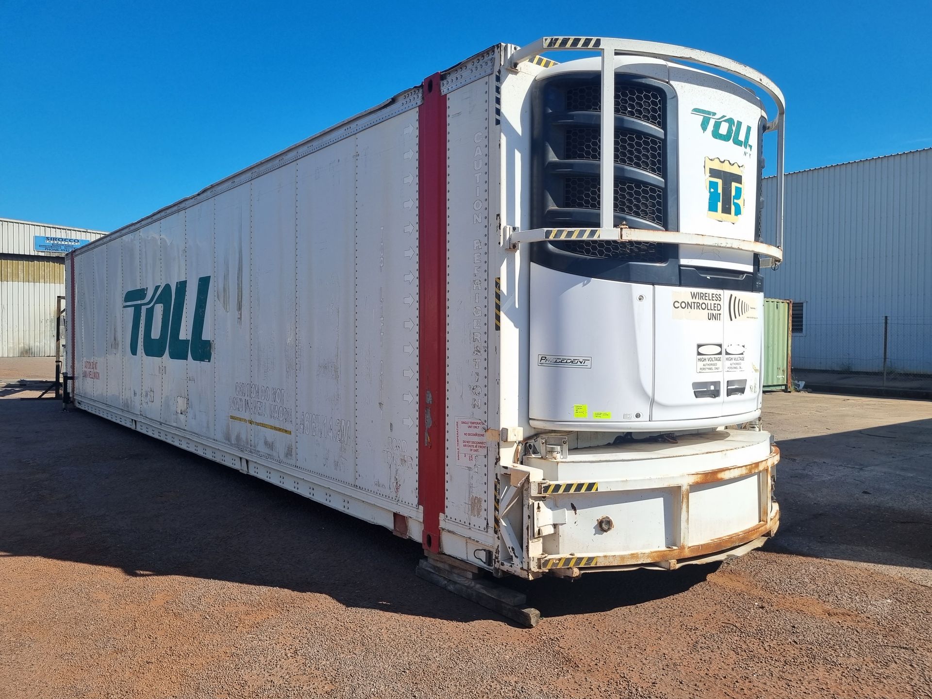 White Toll refrigerated shipping container on dirt under a blue sky — TTS Refrigeration in Pinelands, NT
