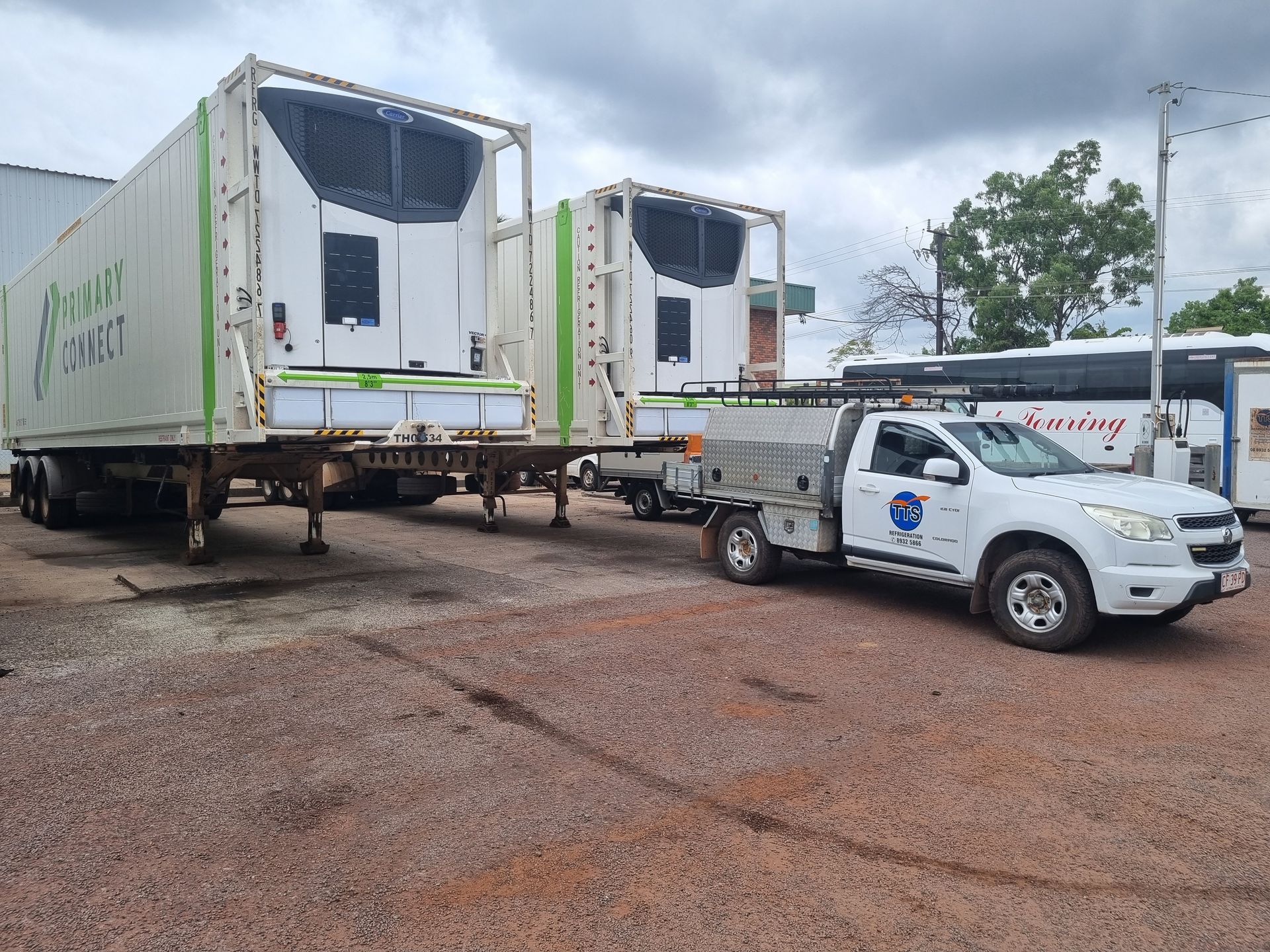 White refrigerated trailers parked next to a white service truck on a gravel lot — TTS Refrigeration in Pinelands, NT