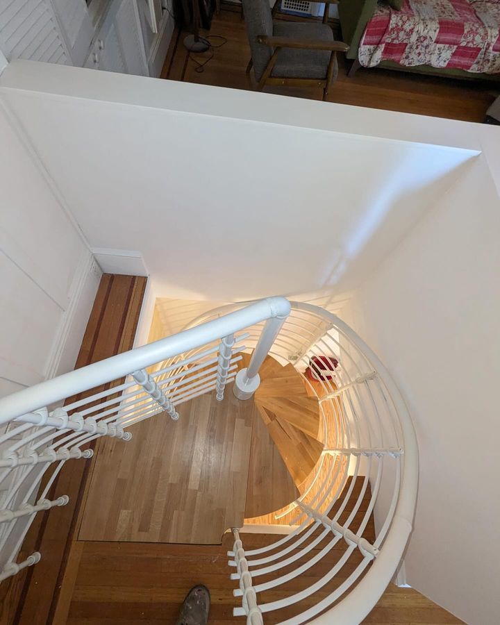 An aerial view of a spiral staircase with a white railing