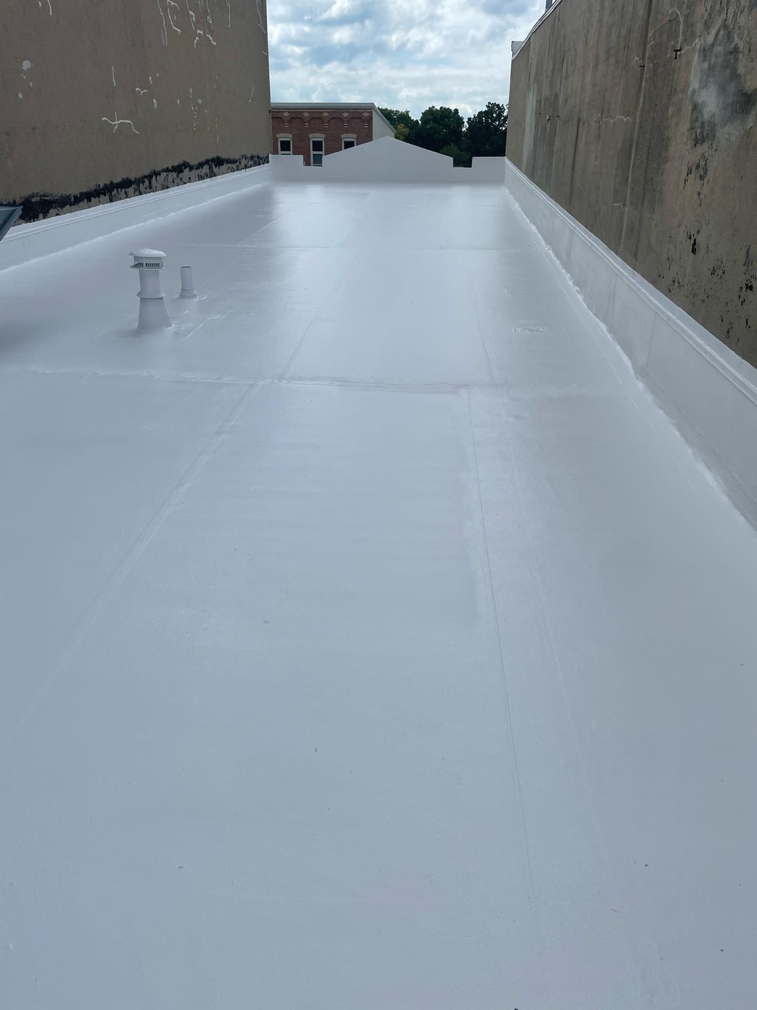 A White Roof with A Drain on The Side of It — Waverly, IA — Star Line Coatings