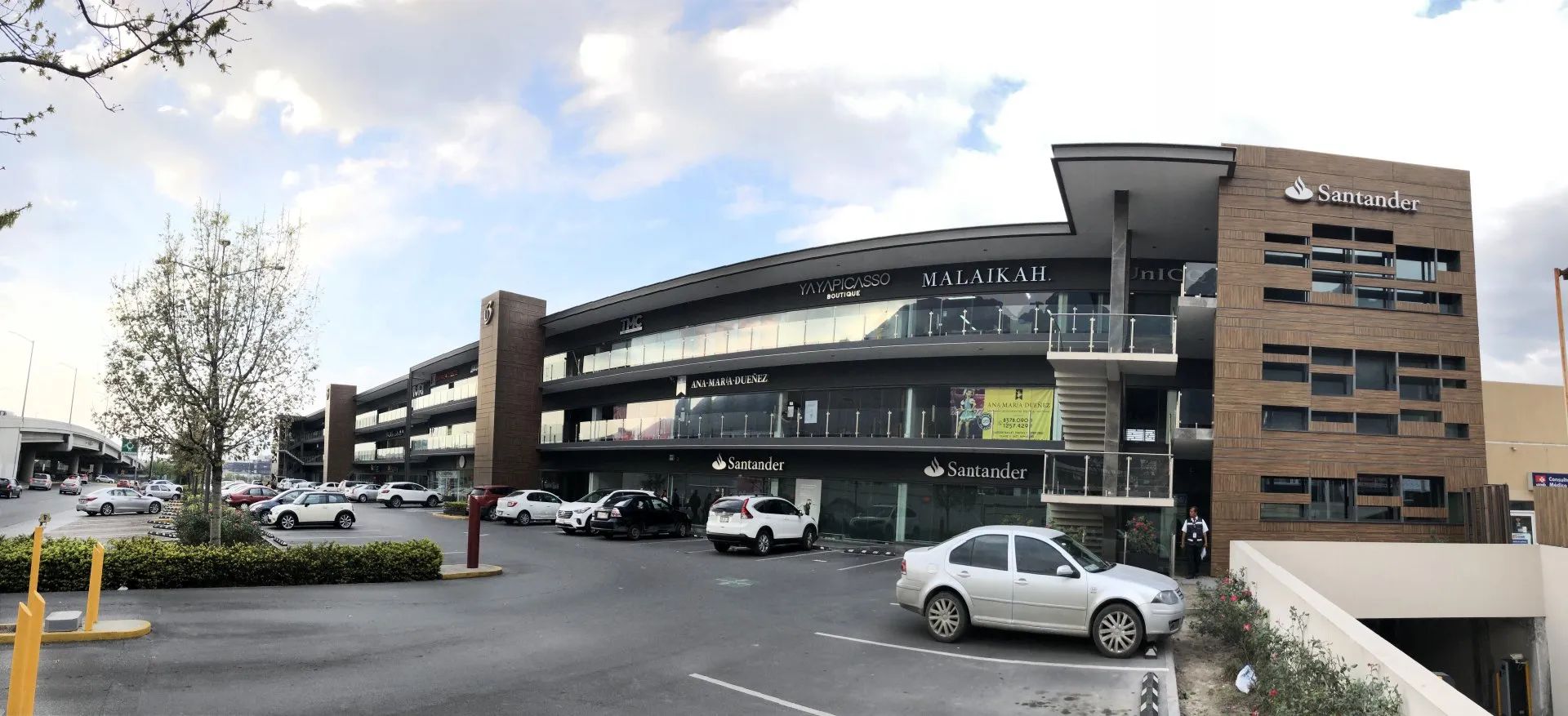 Imagen del frente lateral de U3 plaza comercial con vista al estacionamiento 