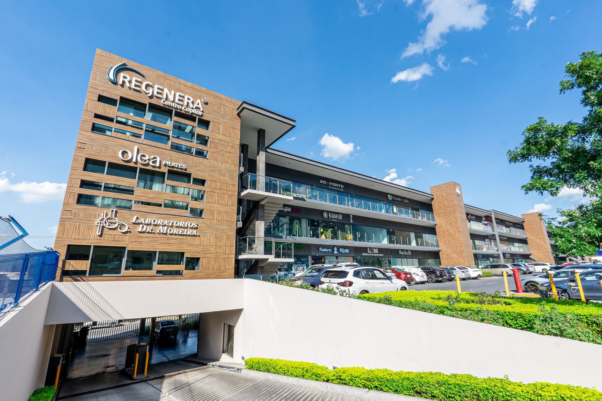 U3 Plaza: Modern brick office building with parking lot, white ramp, and blue sky Plaza: