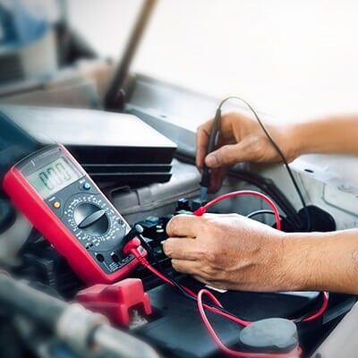 Checking Battery With Tester — Light A/C Service in Lexington, KY
