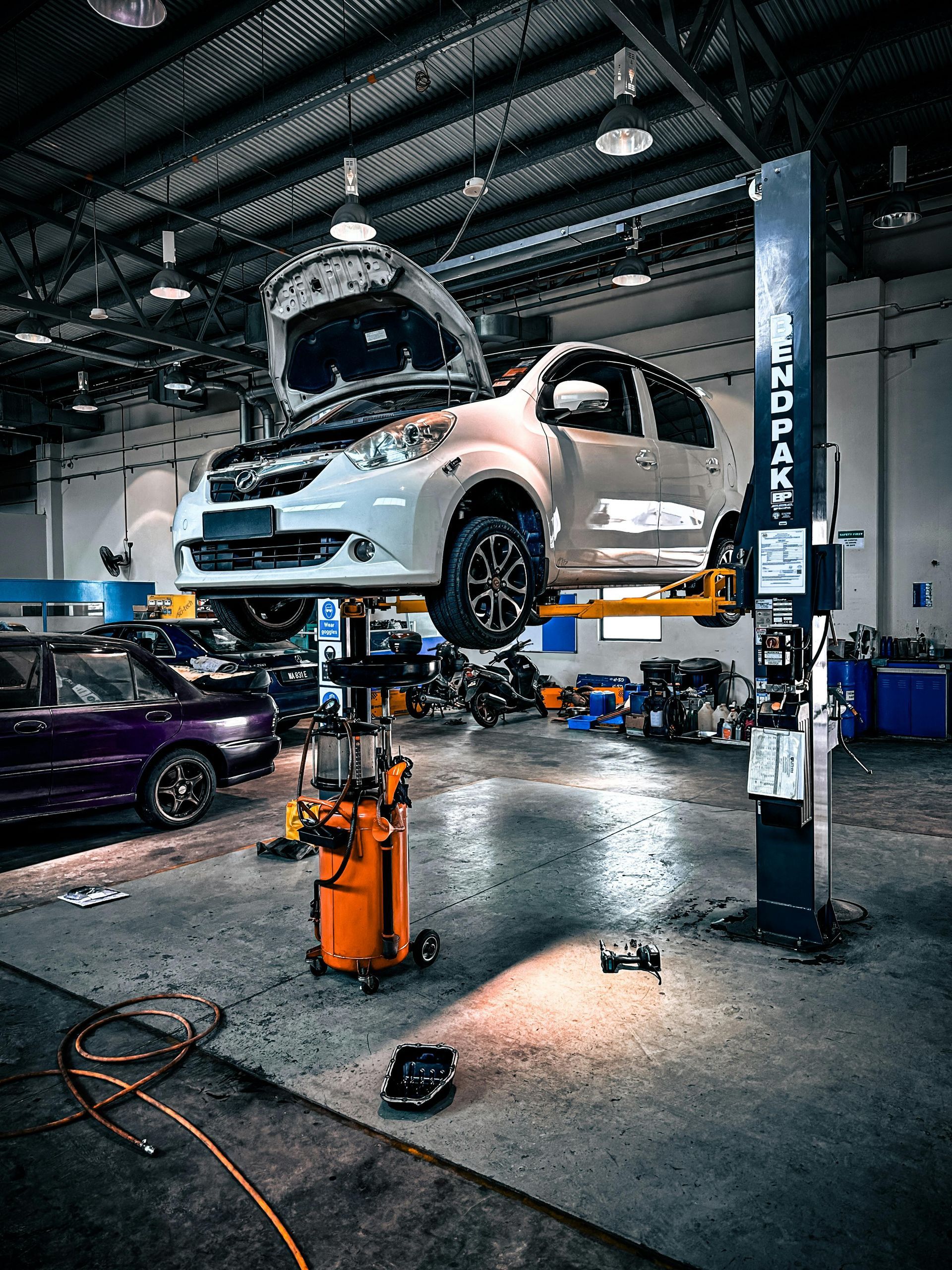 Car Lifted for Auto Repair in Shop | Express Autocare