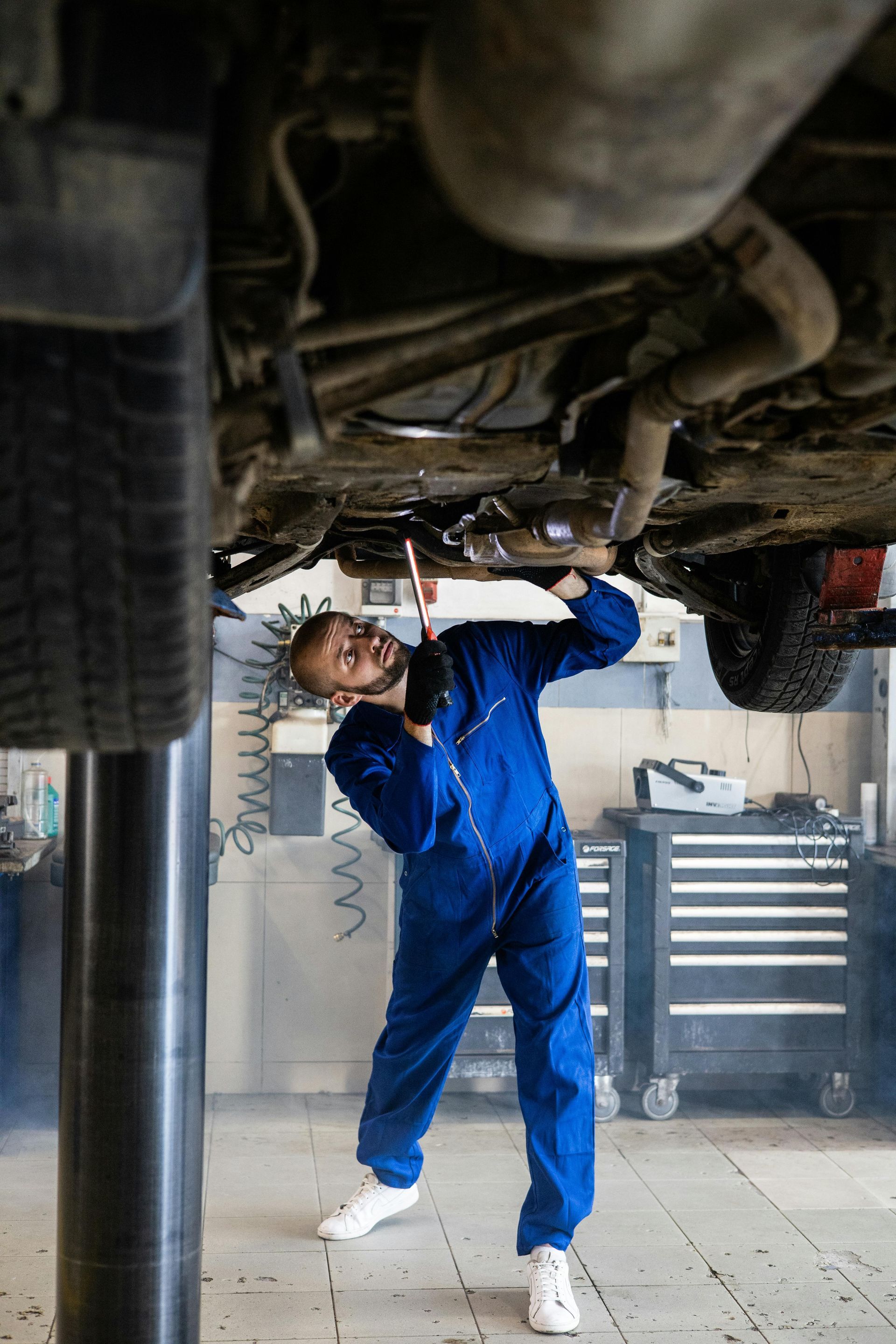 Mechanic Performing Under Car Inspection | Express Autocare