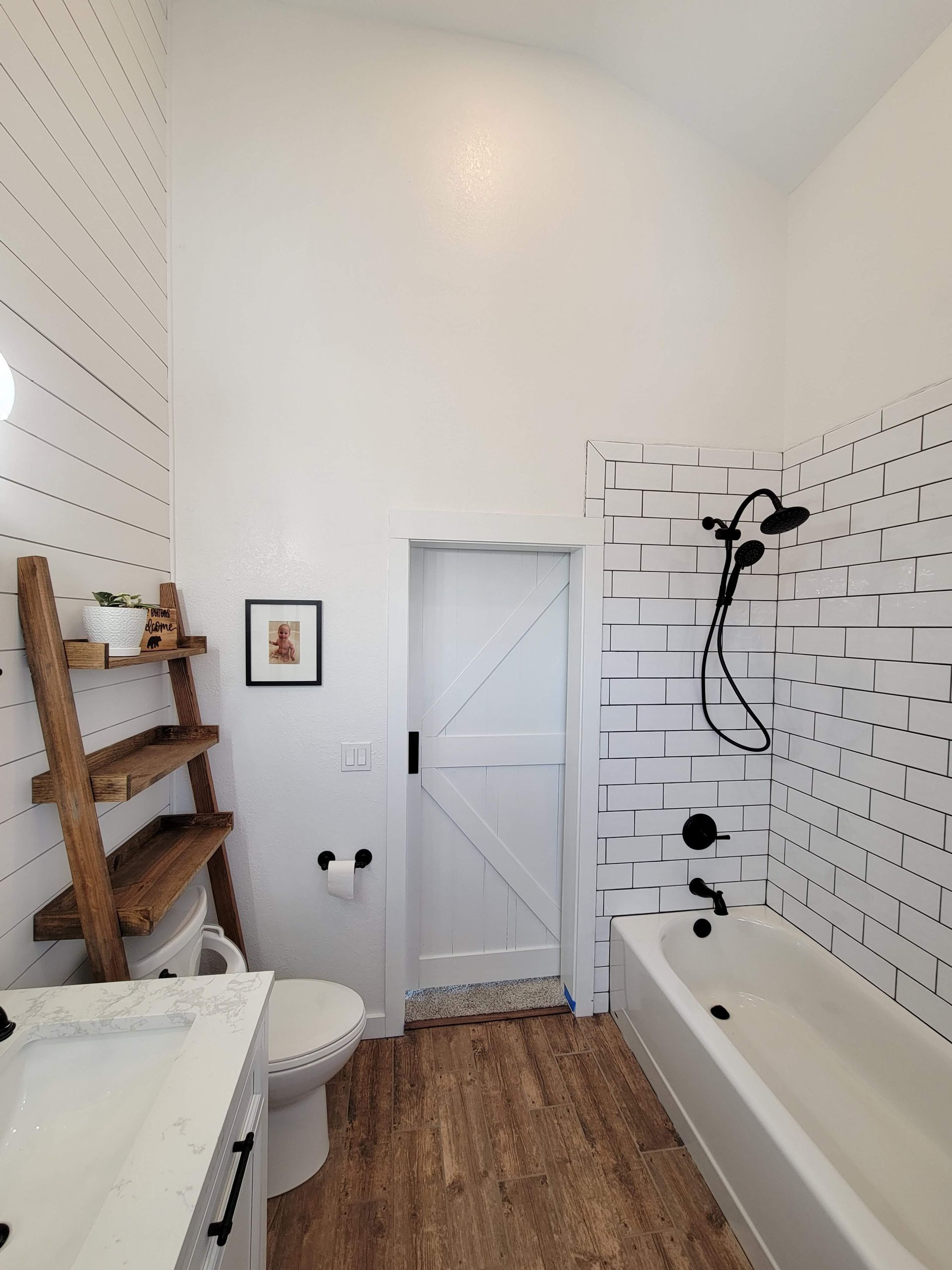 A bathroom with a toilet , sink , bathtub and shower.