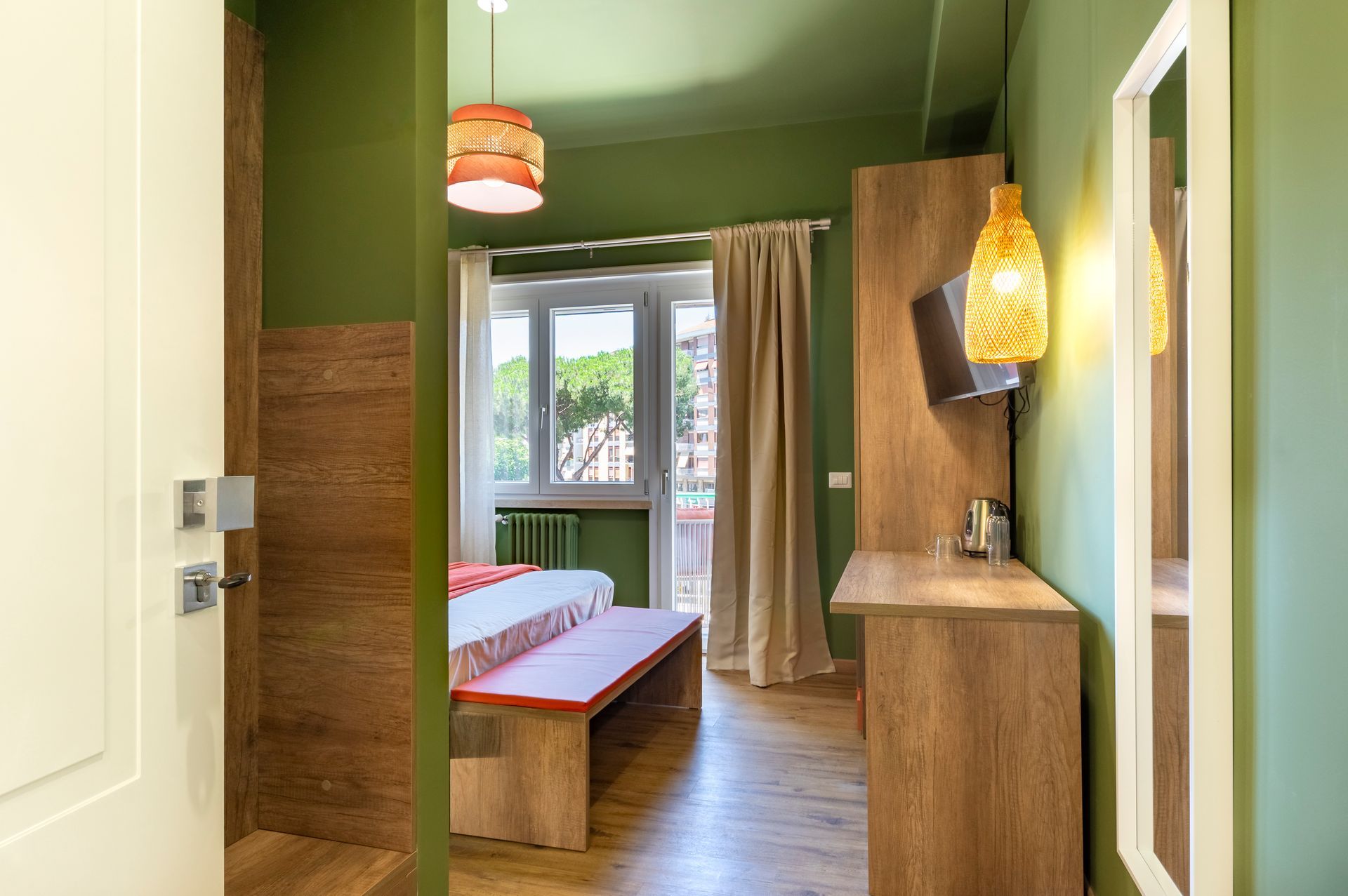 Una camera d'albergo con pareti verdi e un letto