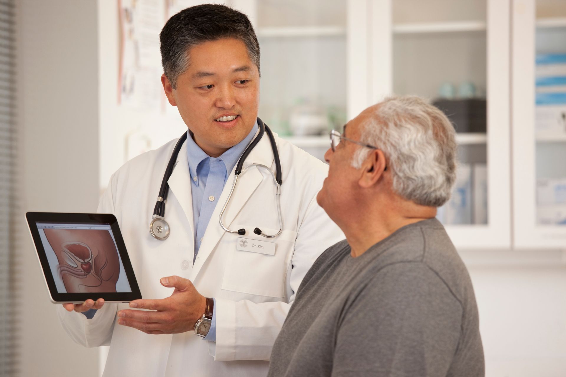 Doctor using digital tablet to talk to senior man. Doctor using digital tablet to talk to senior man.