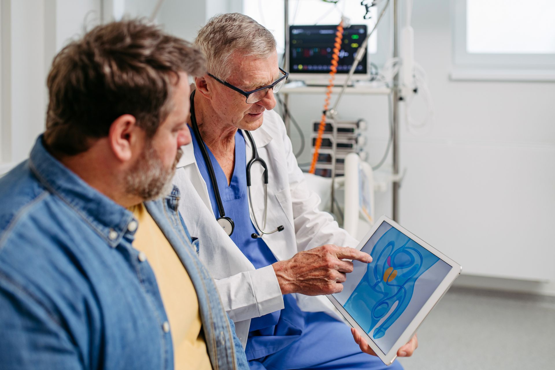 A doctor explaining a prostate exam to a patient during a routine check-up, at a clinic. A doctor explaining a prostate exam to a patient during a routine check-up, at a clinic.