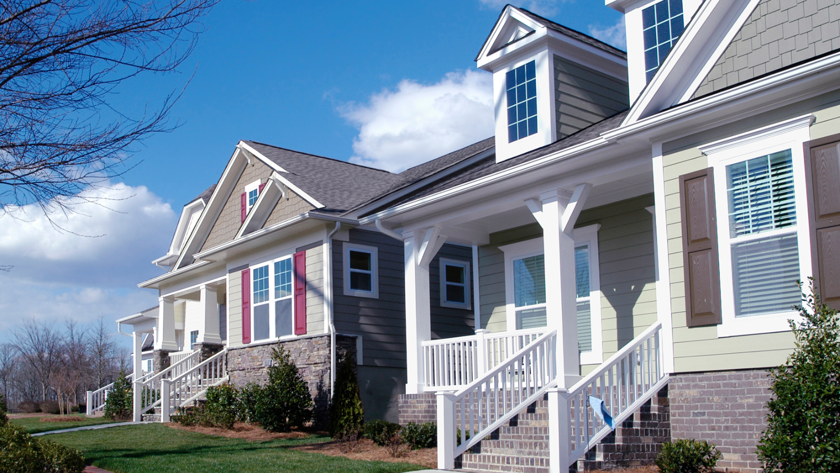 a row of houses with a blue sky in the background
