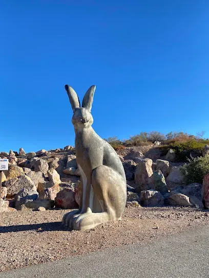 Mobile IVTherapyLas Vegas-A large jackrabbit statue sits prominently on a rocky desert landscape under a clear blue sky, conveying a sense of whimsy and tranquility.