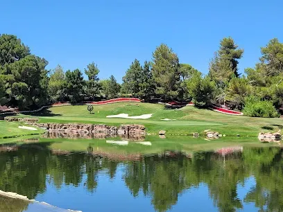 Mobile IV Therapy Las Vegas-Golf course scene with water in the foreground, green grass, sand traps, and trees under a clear blue sky.