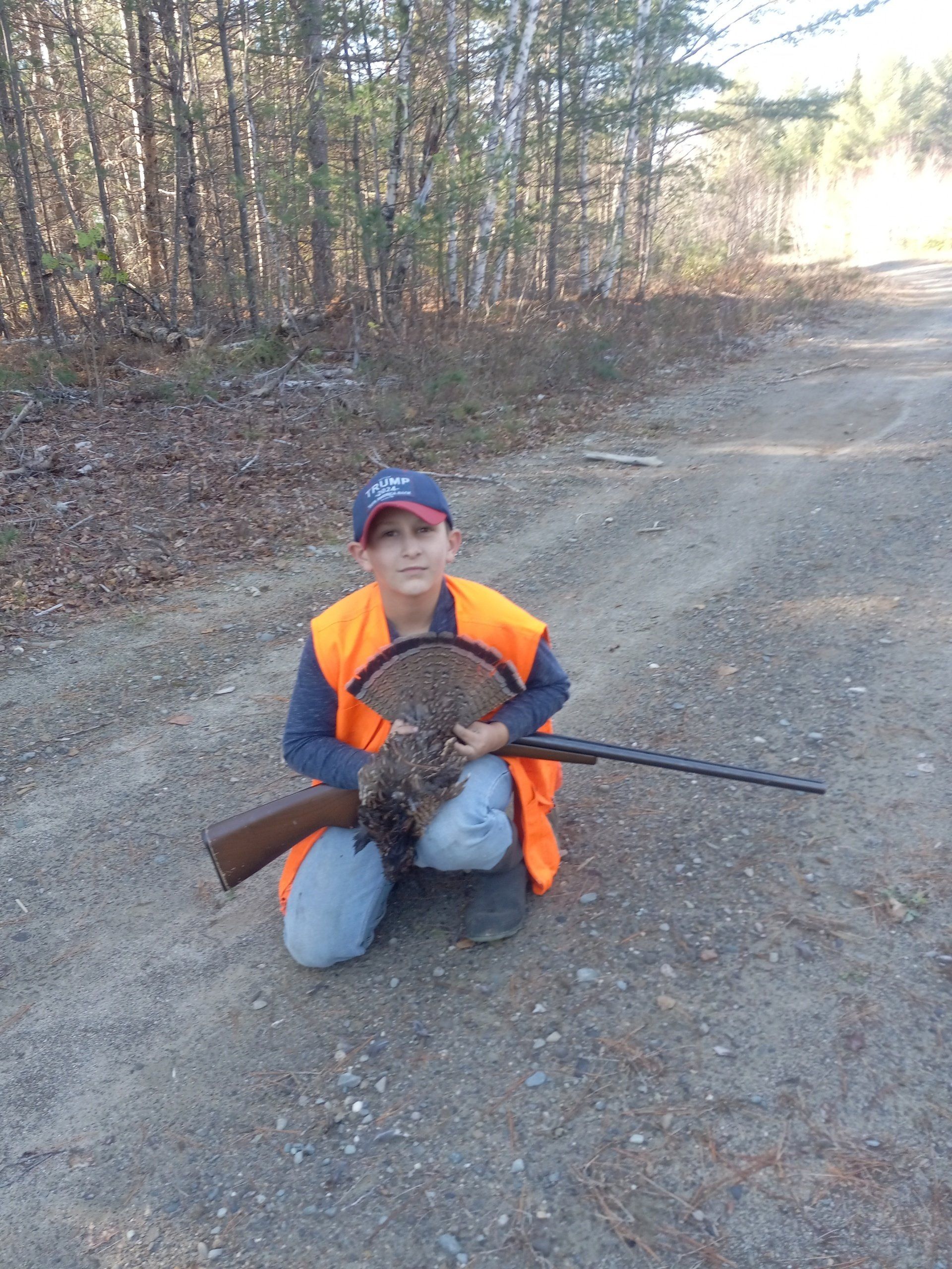 boy with grouse in guided hunt in maine