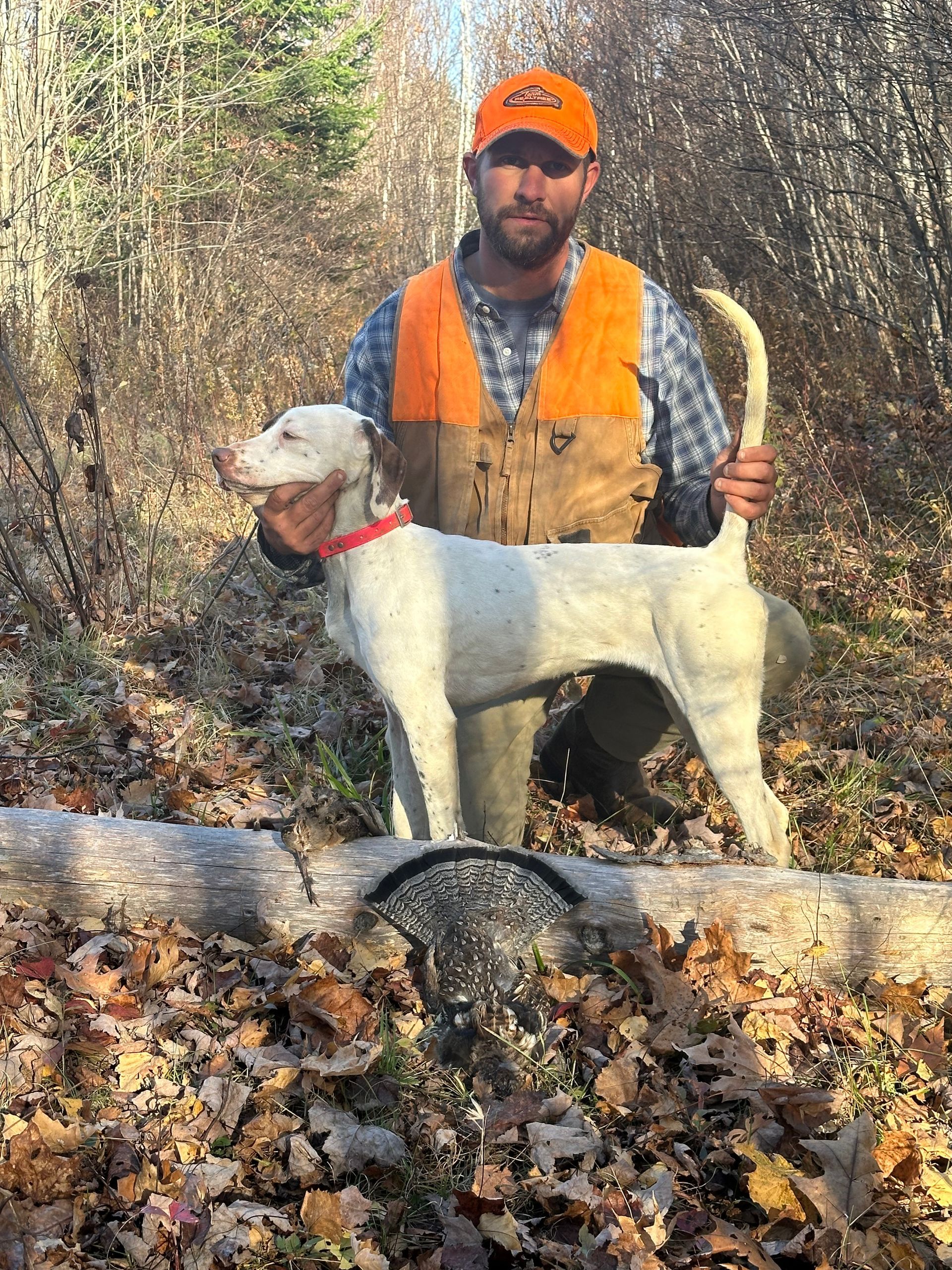 A man is holding a dog on top of a plastic crate