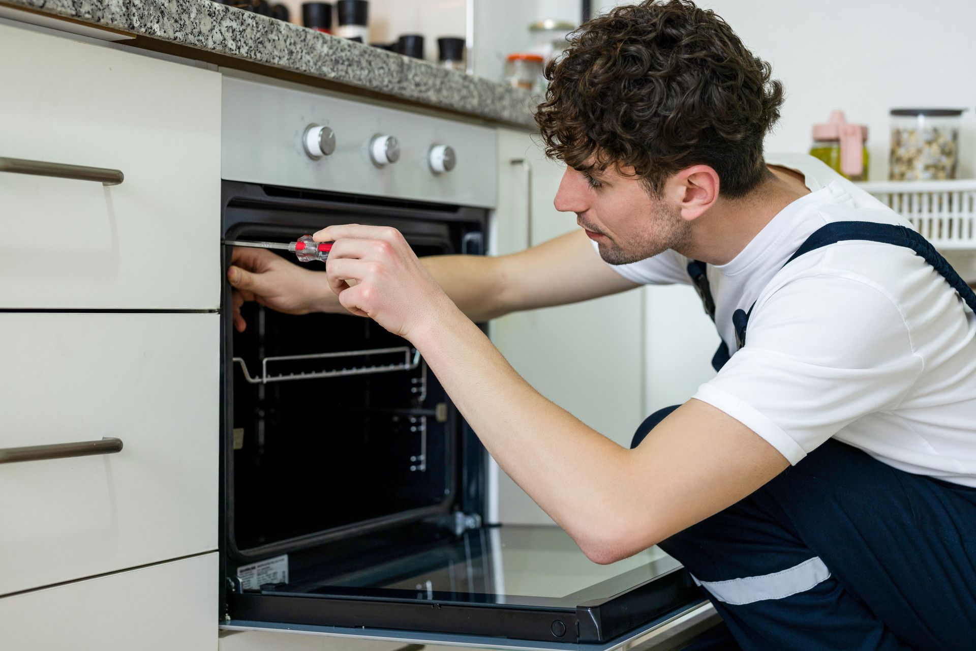 Repairman working on a Kitchen Appliance