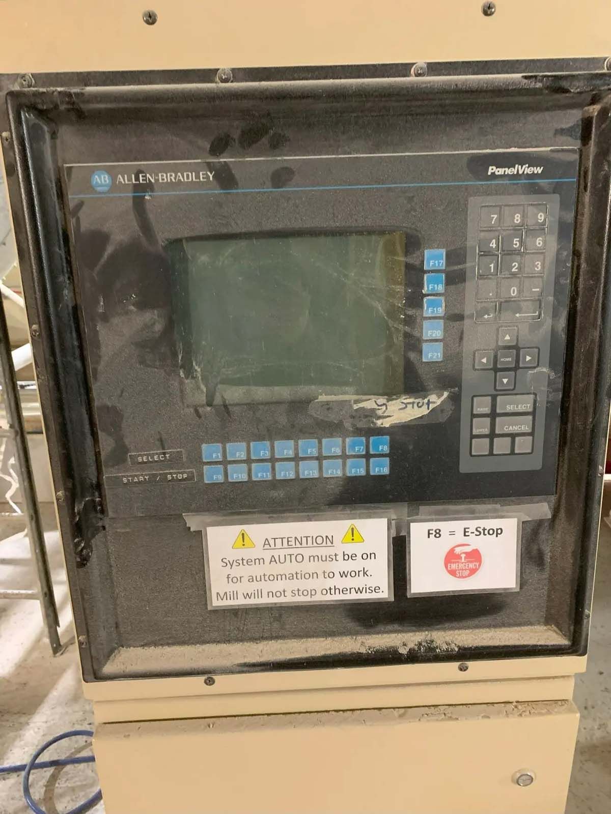A dirty control panel with a warning sign on it.